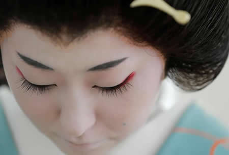 Koiku, uma gueixa, prepara-se para trabalhar durante uma festa num restaurante de luxo, em Tóquio, no Japão
